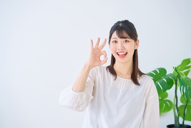 OKのハンドサインをする若い女性